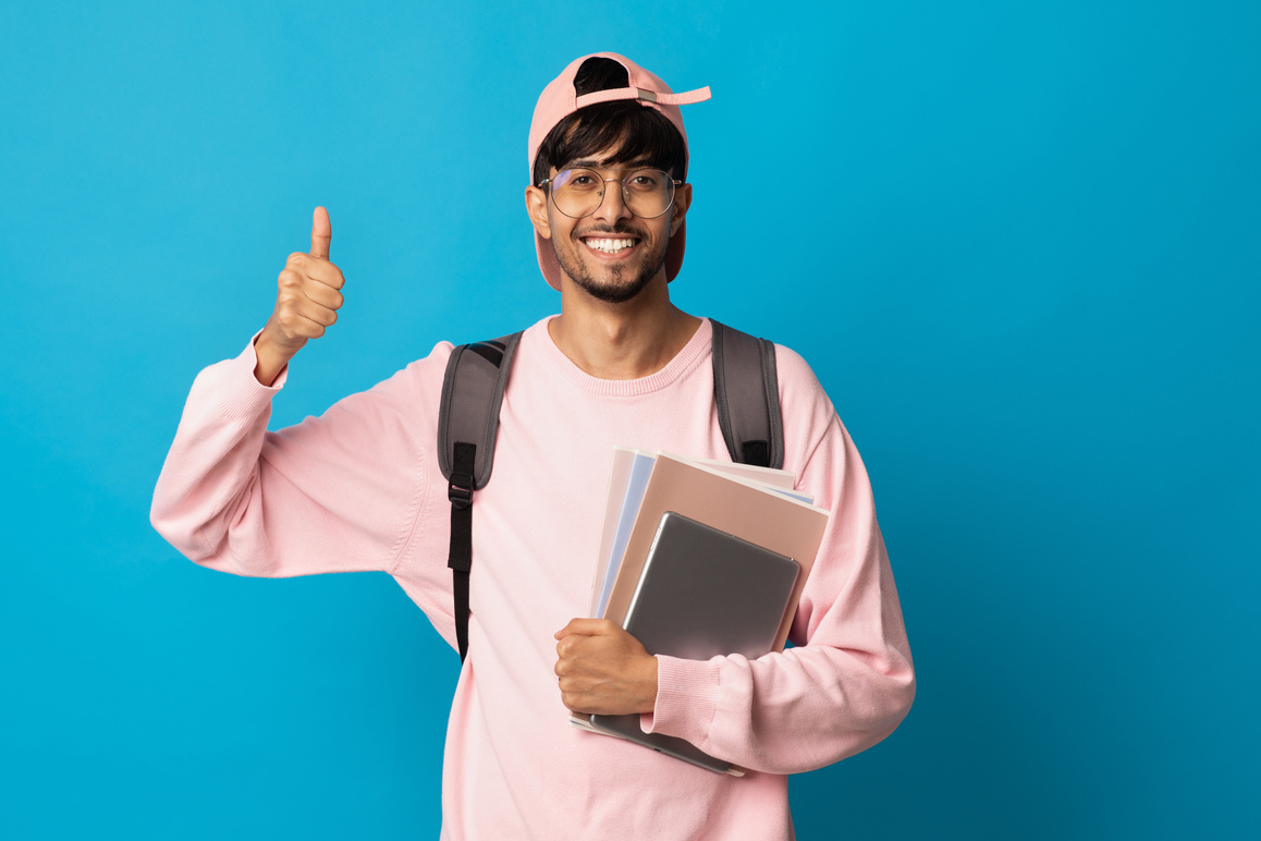 Happy Indian Guy Student with Backpack and Books